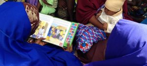 Families perusing a Speaking Books book.