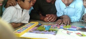 Children reading a Speaking Books book.